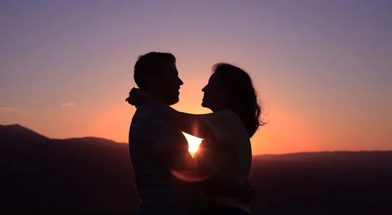 A couple embracing at sunset