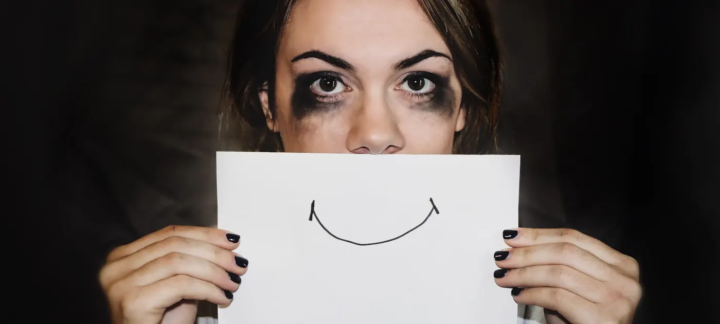 Two people sitting apart, looking away from each other