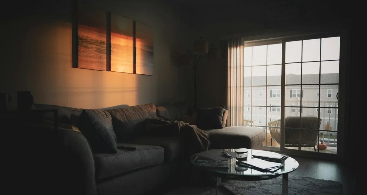 A quiet living room in the low light of early evening